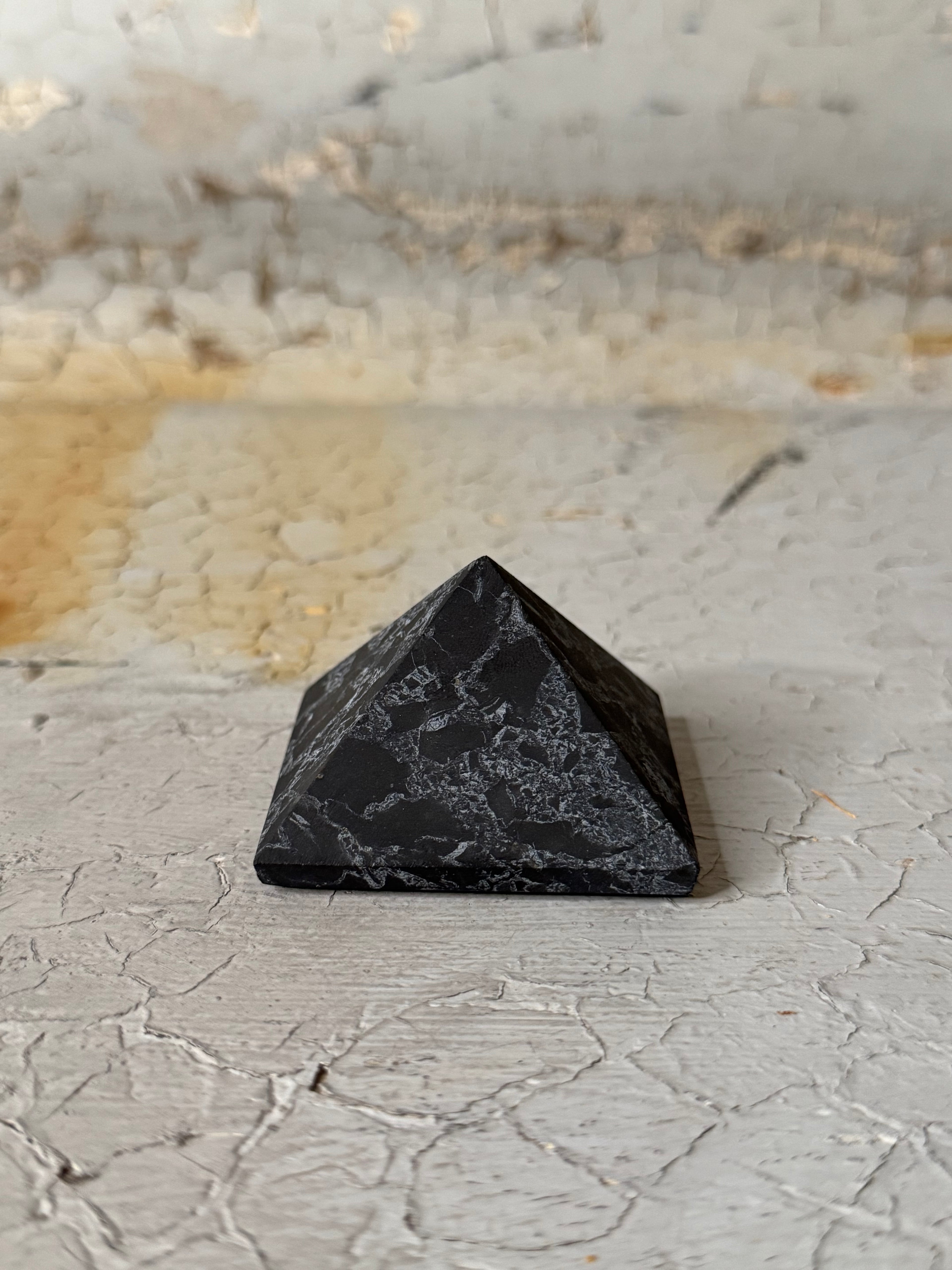 Shungite pyramid with quartz veins