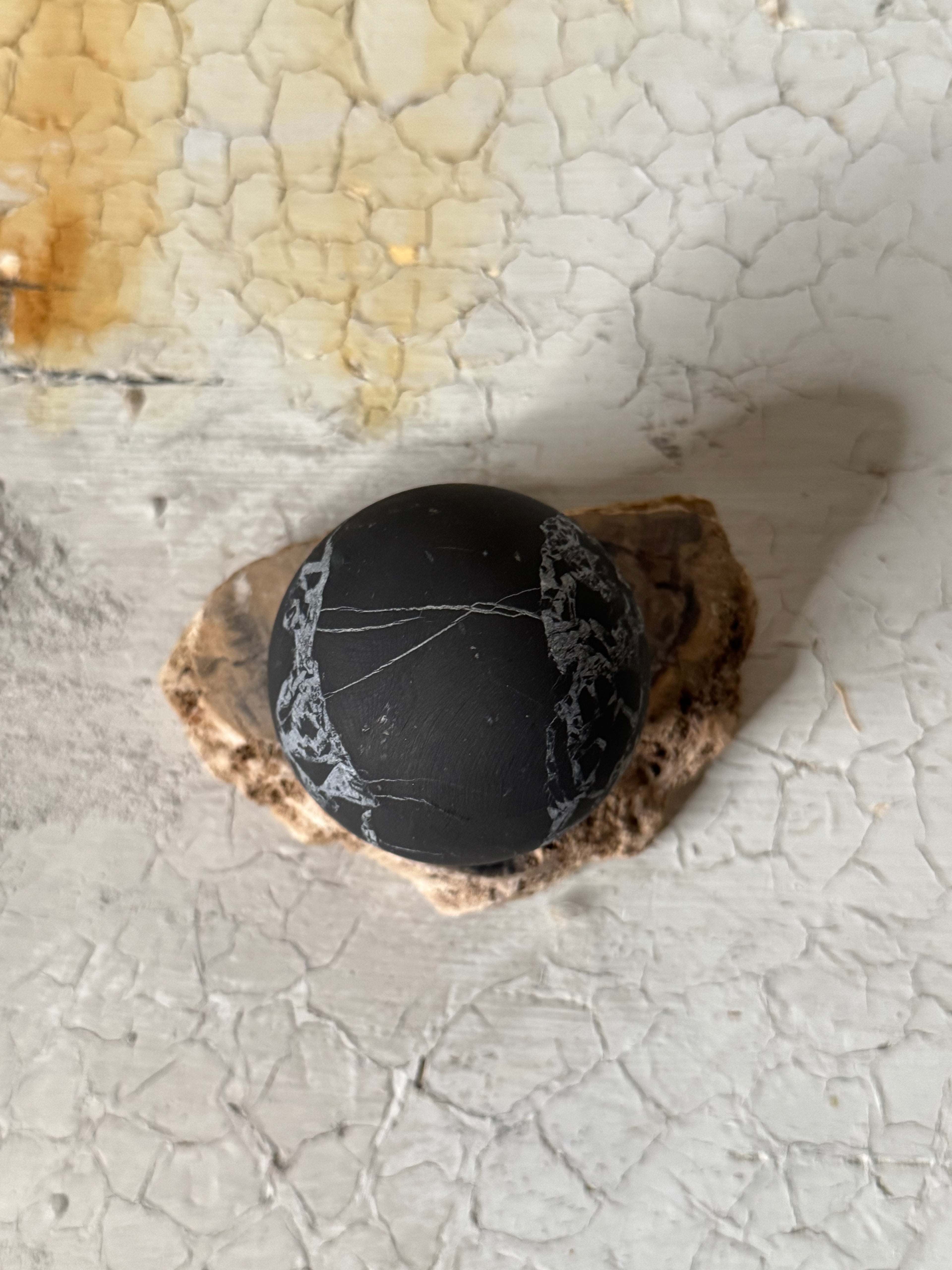 Shungite sphere with quartz veins