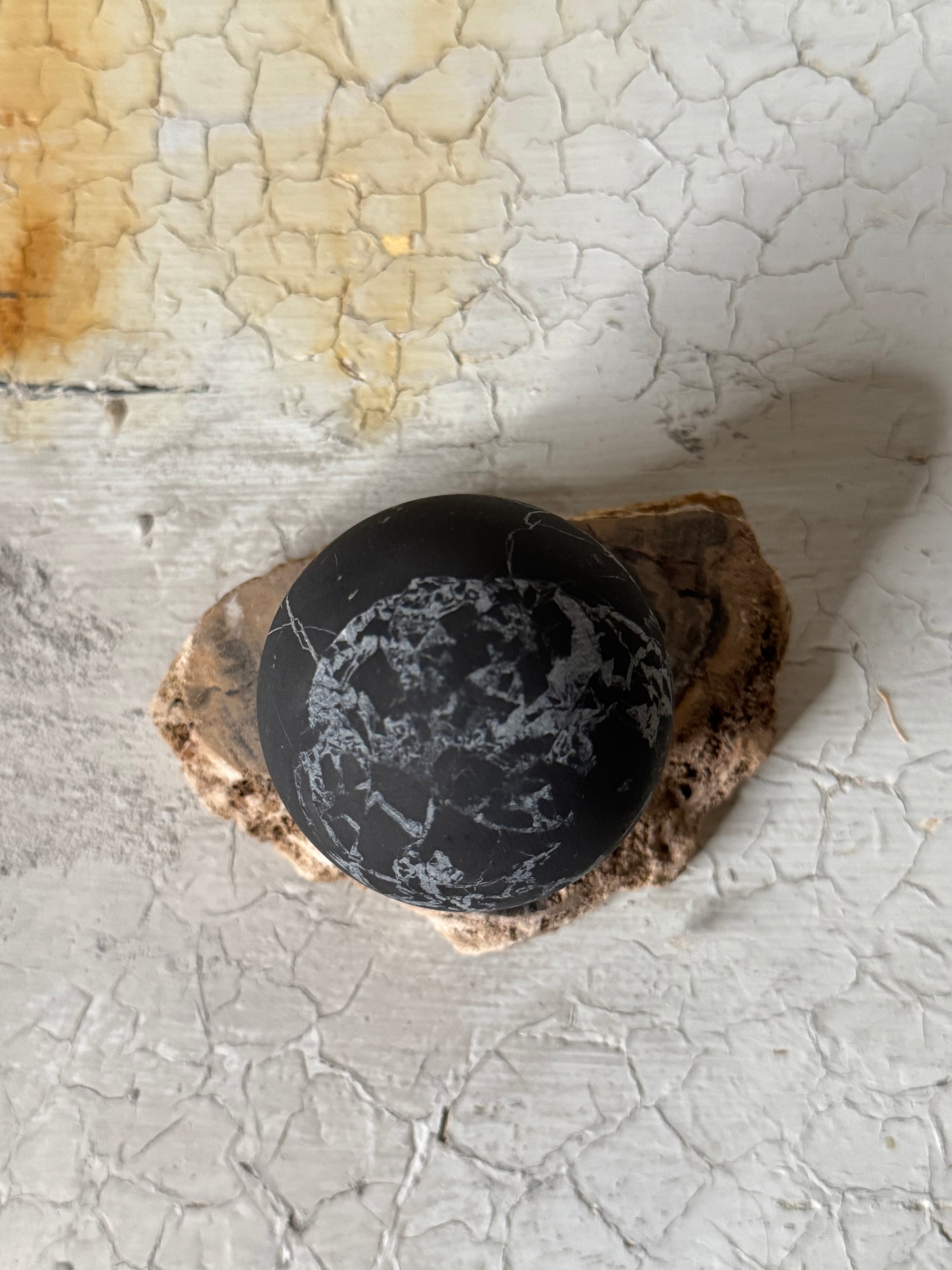 Shungite sphere with quartz veins