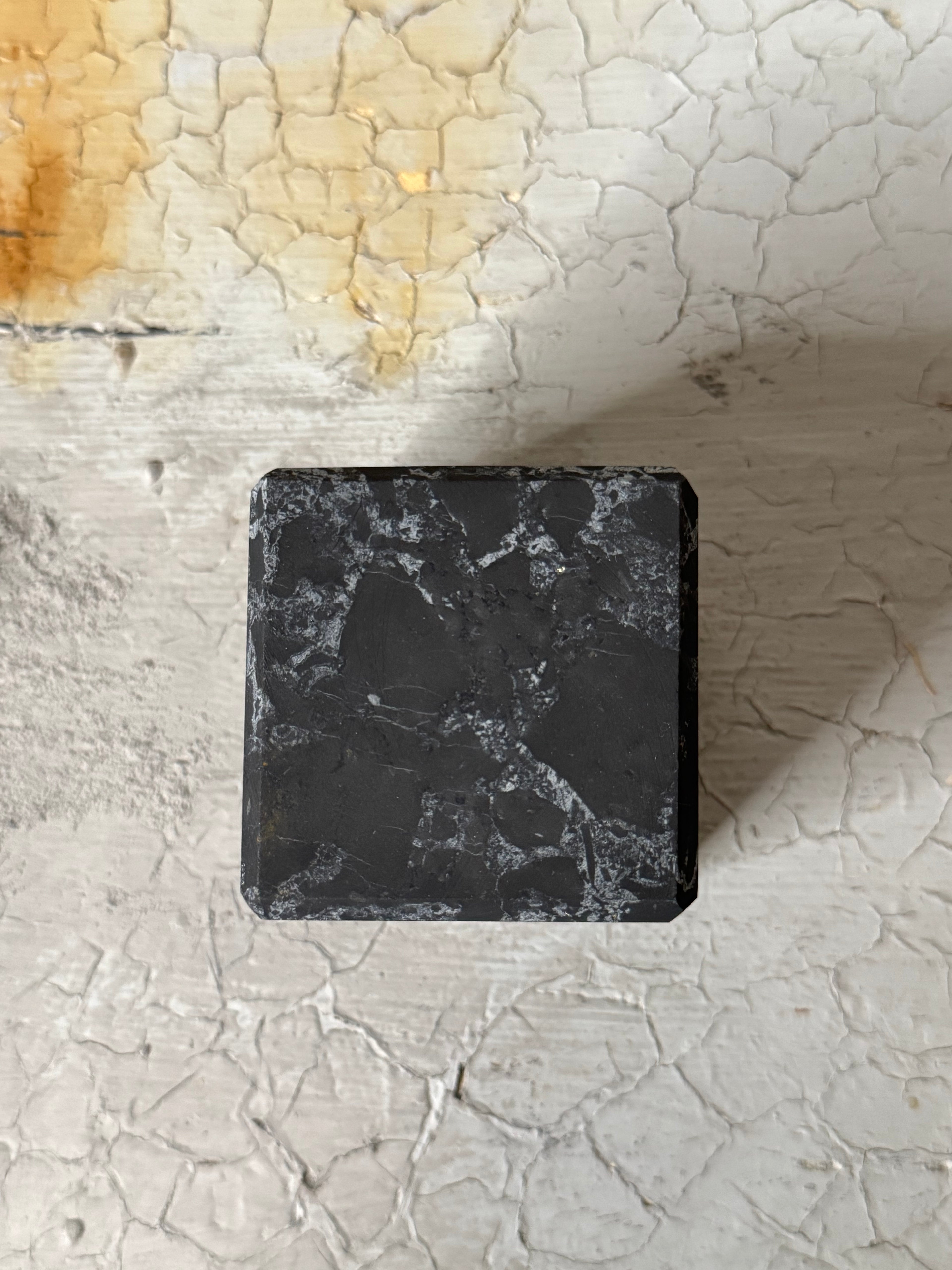 Shungite cube with quartz veins