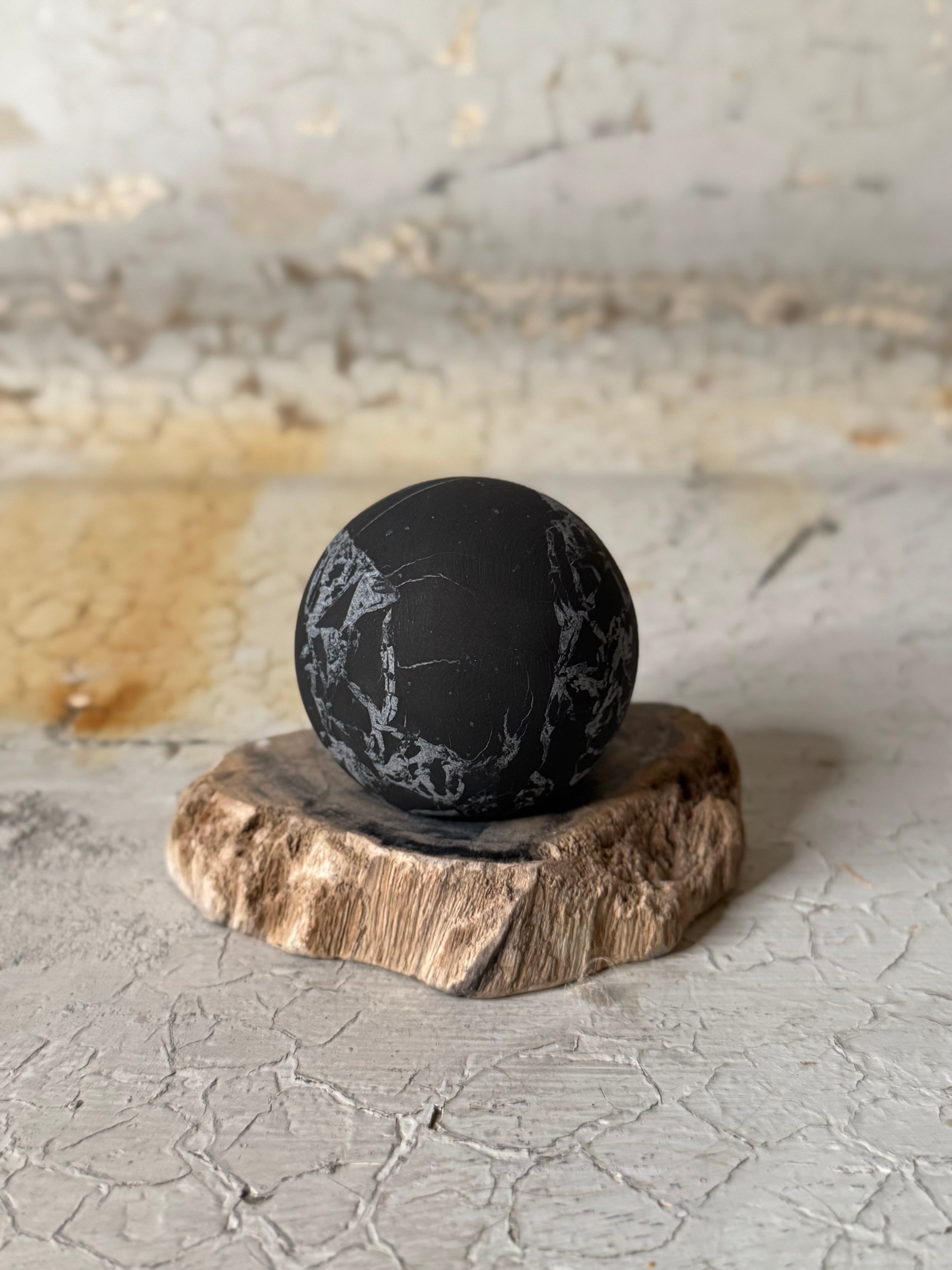 Shungite sphere with quartz veins