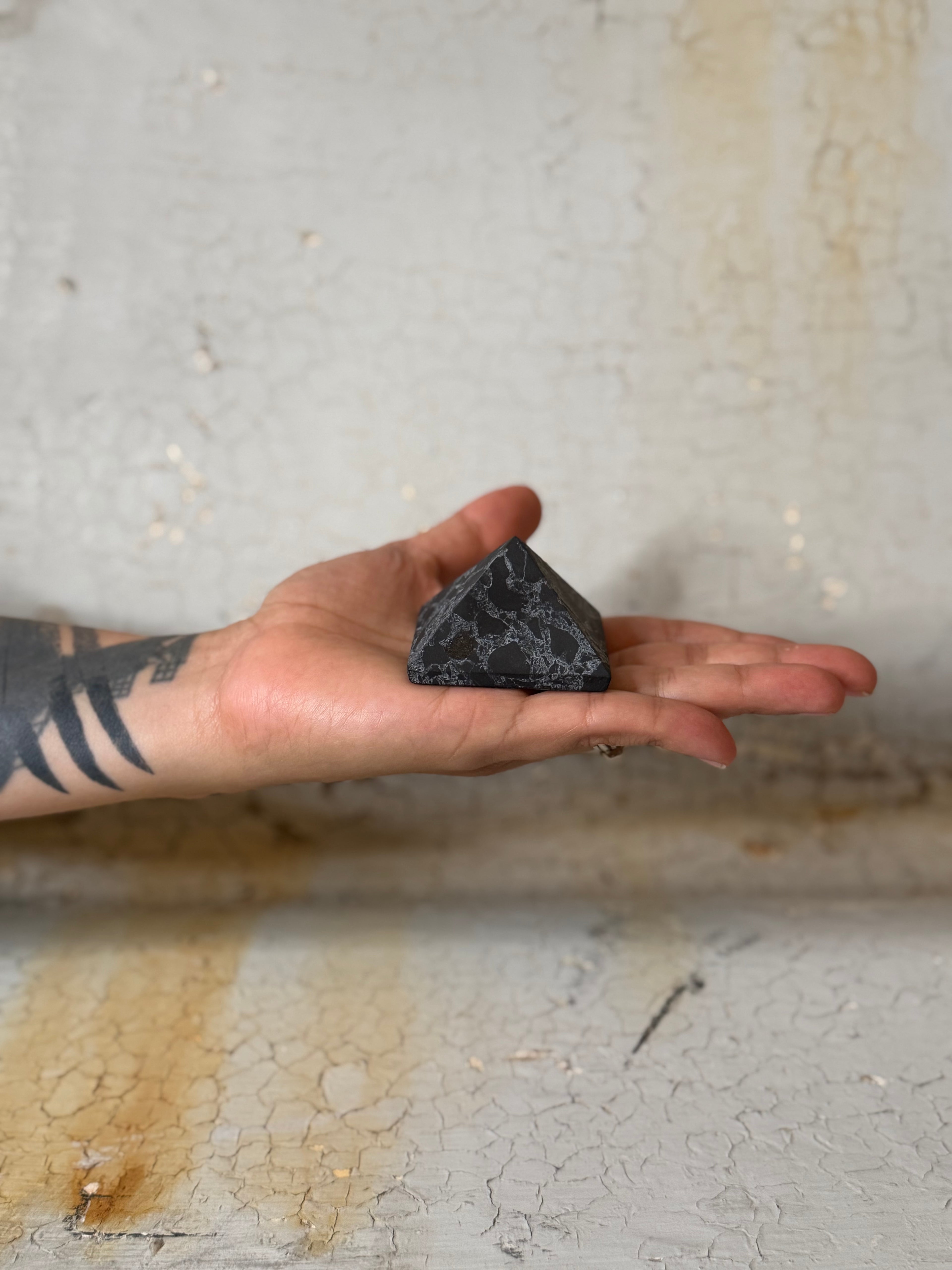 Shungite pyramid with quartz veins